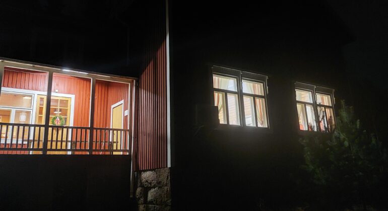 Pimeässä talon ikkunoista loistavat valot.