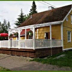 Yellow wooden house with terrace.