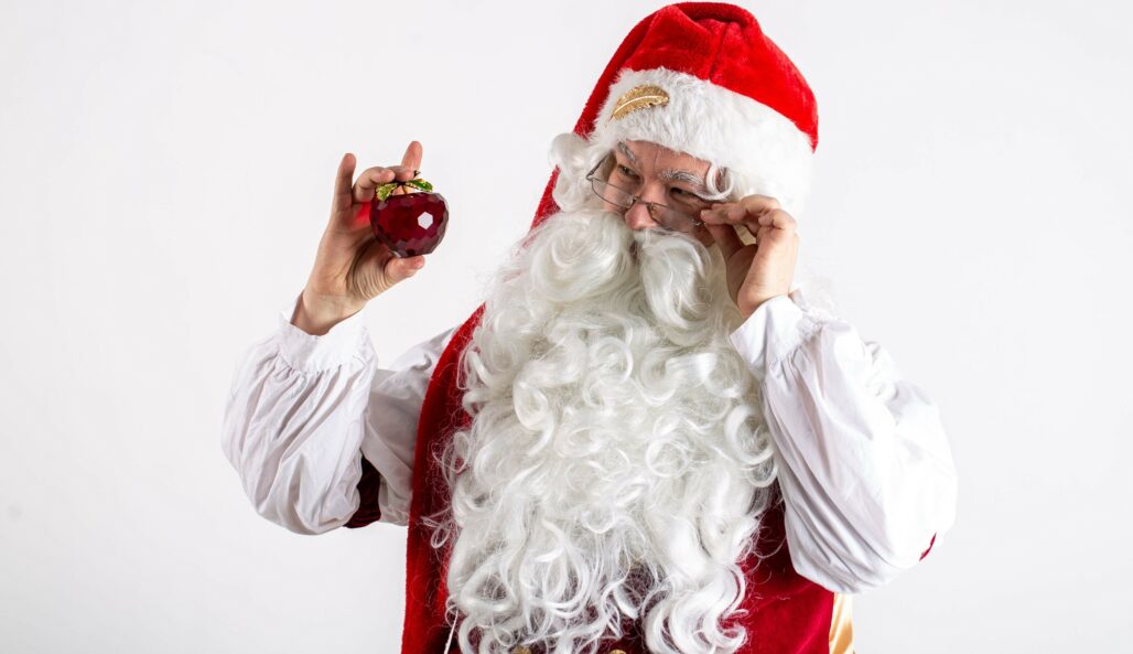 Santa Claus with a Christmas decoration in his hand.