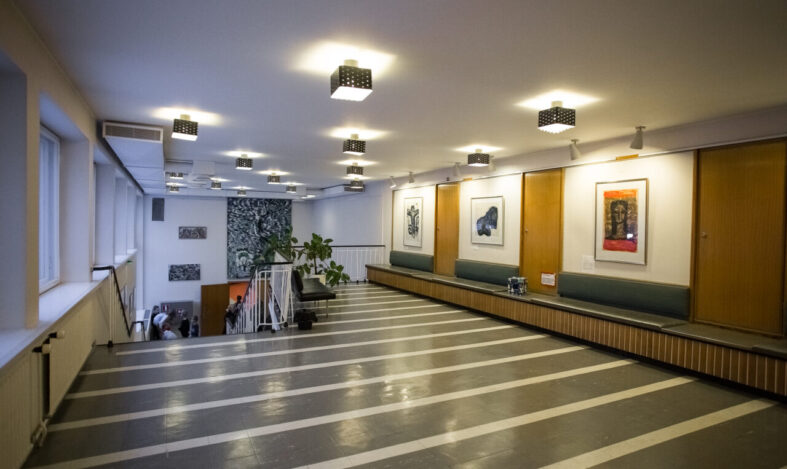 Seuratalon aula, seinillä taidetta.